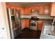 Kitchen with stainless steel appliances, wood cabinets, and dark hardwood flooring at 10264 Headrick Dr, Las Vegas, NV 89166