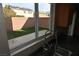 View of a stainless steel sink and a bright backyard through a window at 10264 Headrick Dr, Las Vegas, NV 89166