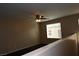 Upstairs loft area with a view, featuring a ceiling fan and neutral walls at 10264 Headrick Dr, Las Vegas, NV 89166