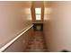 Carpeted staircase with white handrail leading to the next level of the home at 10264 Headrick Dr, Las Vegas, NV 89166