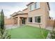 View of backyard with covered patio and turf at 10823 Crestview Pointe Ave, Las Vegas, NV 89166