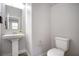 Small bathroom with pedestal sink, toilet, and wood-look flooring at 10823 Crestview Pointe Ave, Las Vegas, NV 89166