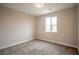 Simple bedroom with grey carpeting and a window at 10823 Crestview Pointe Ave, Las Vegas, NV 89166