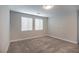 Spacious bedroom with grey carpet and two windows at 10823 Crestview Pointe Ave, Las Vegas, NV 89166