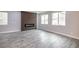 Bright living room with modern fireplace and wood-look floors at 10823 Crestview Pointe Ave, Las Vegas, NV 89166