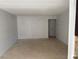 Neutral living room featuring tile flooring, base trim, and access to a hallway at 1405 Vegas Valley Dr # 398, Las Vegas, NV 89169