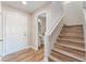 Entryway with stairs, powder room, and light wood flooring at 1512 Groom Ave, North Las Vegas, NV 89081