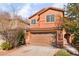 Two-story house with tan exterior, two-car garage, and landscaping at 1512 Groom Ave, North Las Vegas, NV 89081