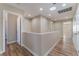 Upstairs hallway with neutral walls and wood-look flooring at 1512 Groom Ave, North Las Vegas, NV 89081