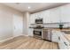 Modern kitchen with white cabinets and stainless steel appliances at 1512 Groom Ave, North Las Vegas, NV 89081