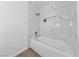 Clean bathroom with a bathtub and marble-tiled walls at 1620 N Torrey Pines Dr # 103, Las Vegas, NV 89108