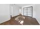 Bright bedroom with wood-look floors and mirrored closet doors at 1620 N Torrey Pines Dr # 103, Las Vegas, NV 89108