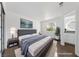 Virtually staged main bedroom with plush bed and en-suite bathroom at 1620 N Torrey Pines Dr # 103, Las Vegas, NV 89108