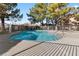 Community swimming pool with surrounding trees and fence at 1620 N Torrey Pines Dr # 103, Las Vegas, NV 89108