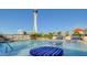 Elevated pool with striped lounge chairs and cityscape view at 200 W Sahara Ave # 2806, Las Vegas, NV 89102