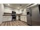 Modern kitchen with stainless steel appliances and wood-look floors at 2136 Chertsey Dr # A, Las Vegas, NV 89108