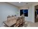 Formal dining room featuring a large wood table and six chairs at 2214 Brighton Point Ave, Henderson, NV 89044