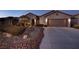 Single story home with a two-car garage, attractive landscaping and exterior lighting at 2214 Brighton Point Ave, Henderson, NV 89044