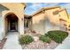 Front entrance with arched entryway and landscaping at 2214 Brighton Point Ave, Henderson, NV 89044