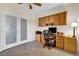 Home office features built-in wood cabinets and a desk at 2214 Brighton Point Ave, Henderson, NV 89044