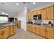 Modern kitchen with light wood cabinets, granite counters and gas range at 2214 Brighton Point Ave, Henderson, NV 89044