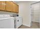 Laundry room with washer, dryer, and adjacent storage at 2214 Brighton Point Ave, Henderson, NV 89044