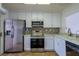 Updated kitchen with stainless steel appliances and white cabinets at 2400 Stadler Ct, Las Vegas, NV 89134