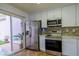 Updated kitchen with stainless steel appliances and white cabinets at 2400 Stadler Ct, Las Vegas, NV 89134