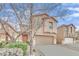 Two-story house with attached garage and landscaping at 2505 Cockatiel Dr, North Las Vegas, NV 89084