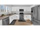 Well-equipped kitchen featuring white cabinetry and stainless steel appliances at 2505 Cockatiel Dr, North Las Vegas, NV 89084