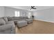 Spacious living room featuring a large sectional sofa and light hardwood floors at 2505 Cockatiel Dr, North Las Vegas, NV 89084