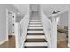 Modern staircase with white railings and dark wood steps at 2505 Cockatiel Dr, North Las Vegas, NV 89084