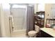 A well-lit bathroom with a shower-tub combination and a storage shelf for toiletries at 2509 Piacenza Pl, Henderson, NV 89044