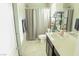 Neutral bathroom featuring a shower/tub combo, tile floor, and modern vanity with a white countertop at 2509 Piacenza Pl, Henderson, NV 89044