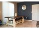 The dining area features a farmhouse table with bench seating and a modern round mirror at 2509 Piacenza Pl, Henderson, NV 89044