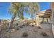 Relaxing backyard patio area with gravel and a large tree at 2551 Darda St, Henderson, NV 89044