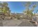 Landscaped backyard with gravel, patio, and mature trees at 2551 Darda St, Henderson, NV 89044