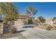 Single-story home with stone accents and a two-car garage. Landscaped front yard at 2551 Darda St, Henderson, NV 89044