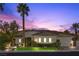 Stunning single-story home with a tile roof and desert landscaping at sunset at 2575 Grassy Spring Pl, Las Vegas, NV 89135