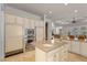 Modern kitchen with large island, stainless steel appliances, and custom cabinetry at 2575 Grassy Spring Pl, Las Vegas, NV 89135