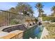 Resort-style pool with waterfall feature and lush landscaping at 2575 Grassy Spring Pl, Las Vegas, NV 89135