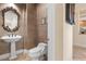 Chic powder room with pedestal sink and decorative mirror at 2575 Grassy Spring Pl, Las Vegas, NV 89135