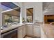 Wet bar with granite countertop, wine cooler, and cabinets at 2575 Grassy Spring Pl, Las Vegas, NV 89135