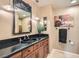 Modern bathroom with dark wood cabinets, black sink, and a large mirror at 2625 Seashore Dr, Las Vegas, NV 89128