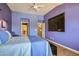 Purple bedroom with built-in TV and hardwood floors at 2625 Seashore Dr, Las Vegas, NV 89128