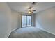 Bright bedroom featuring gray carpeting and sliding glass door to patio at 2714 Bridgepointe Dr, Las Vegas, NV 89121