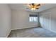 Cozy bedroom with gray carpet, ceiling fan, and sliding closet doors at 2714 Bridgepointe Dr, Las Vegas, NV 89121