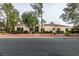 Light colored stucco home with red tile roof and landscaping at 2714 Bridgepointe Dr, Las Vegas, NV 89121