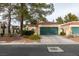 Single story home with green garage door and mature landscaping at 2714 Bridgepointe Dr, Las Vegas, NV 89121