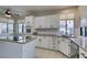 Bright kitchen featuring white cabinets, granite island, and updated sink at 2714 Bridgepointe Dr, Las Vegas, NV 89121